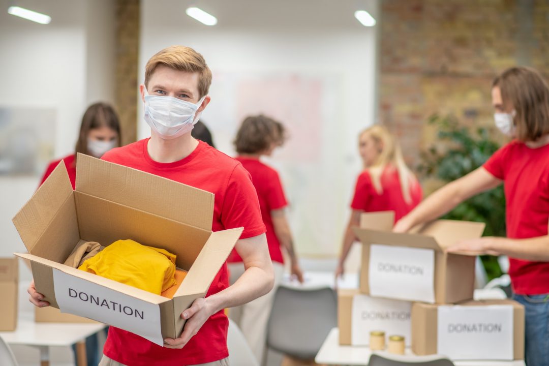 volunteers-in-facial-masks-working-with-donations-sorting.jpg